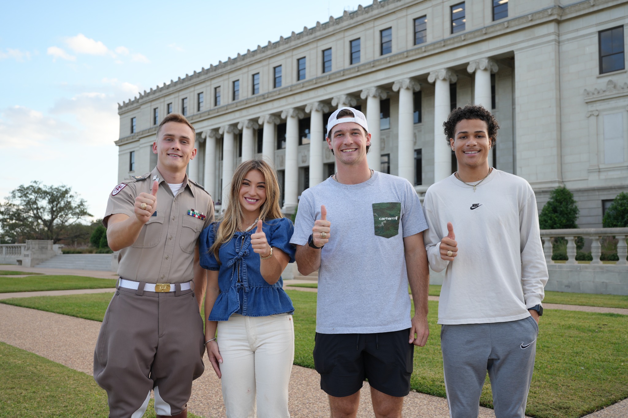Students standing together outside on campus